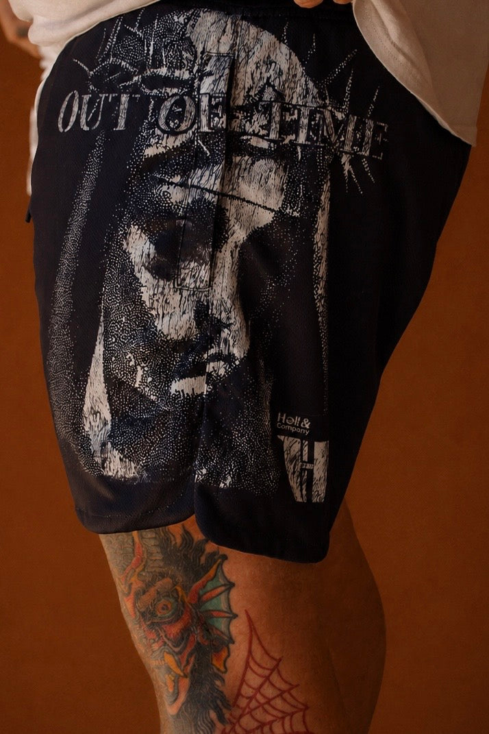 Black shorts with graphic design and text on a brown background