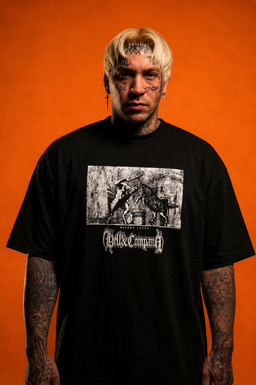 Person wearing a black t-shirt with graphic design and text against an orange background