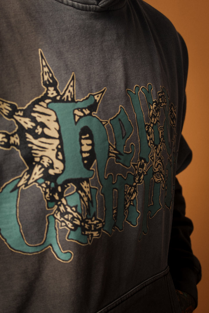 Close-up of a hoodie with a decorative logo on a brown background